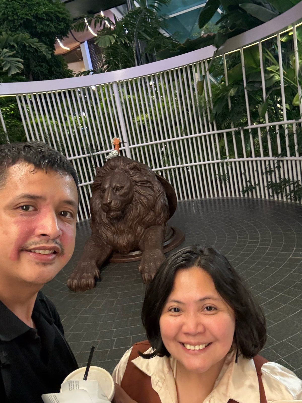 Bronze lion sculpture in The Orchard, the indoor garden at Hamad International Airport, Doha