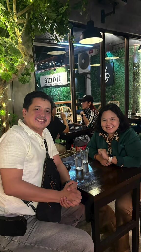 The two of us at our table by the Ambit sign at Ambit Cafe & Bar