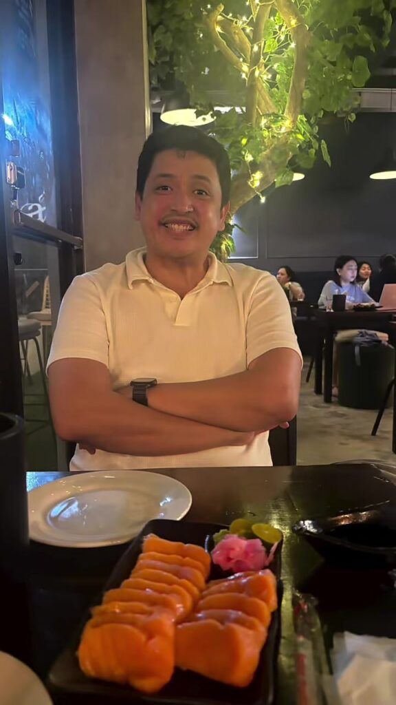Paolo with our salmon sashimi at Ambit Cafe & Bar