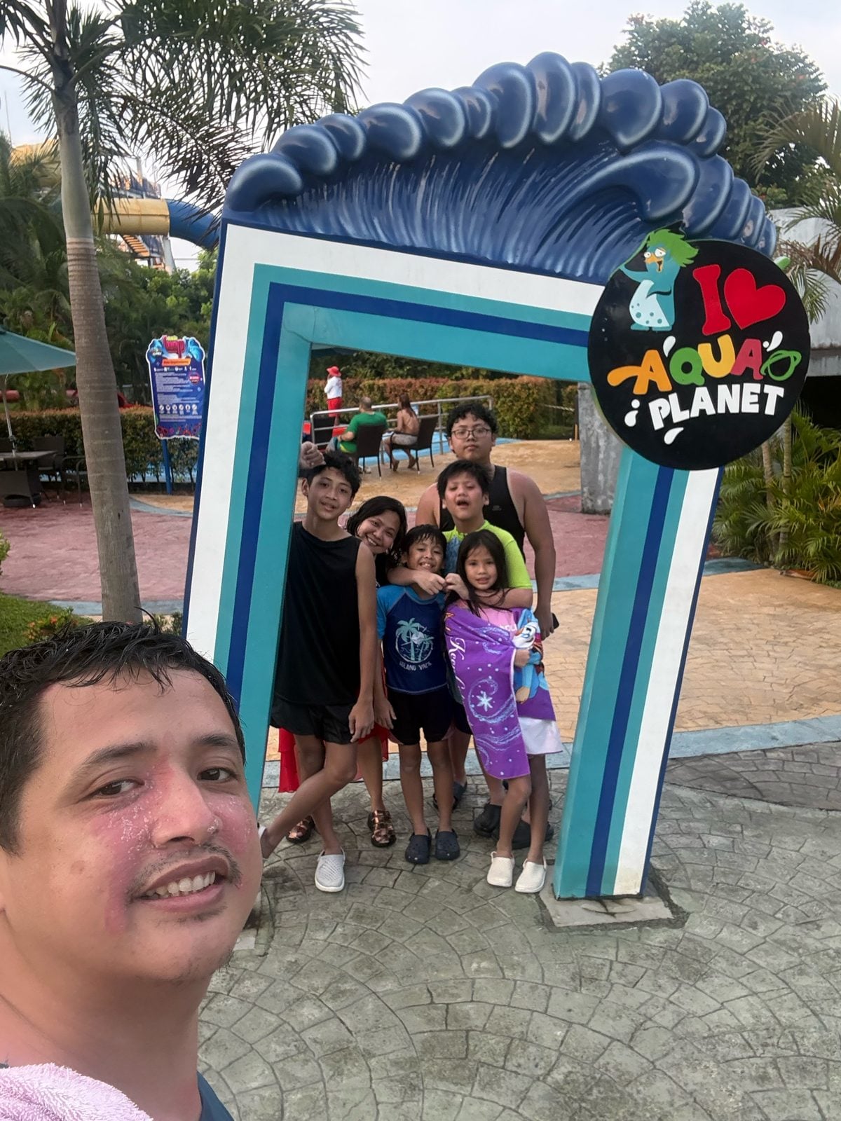 The family together at the Aqua Planet arch