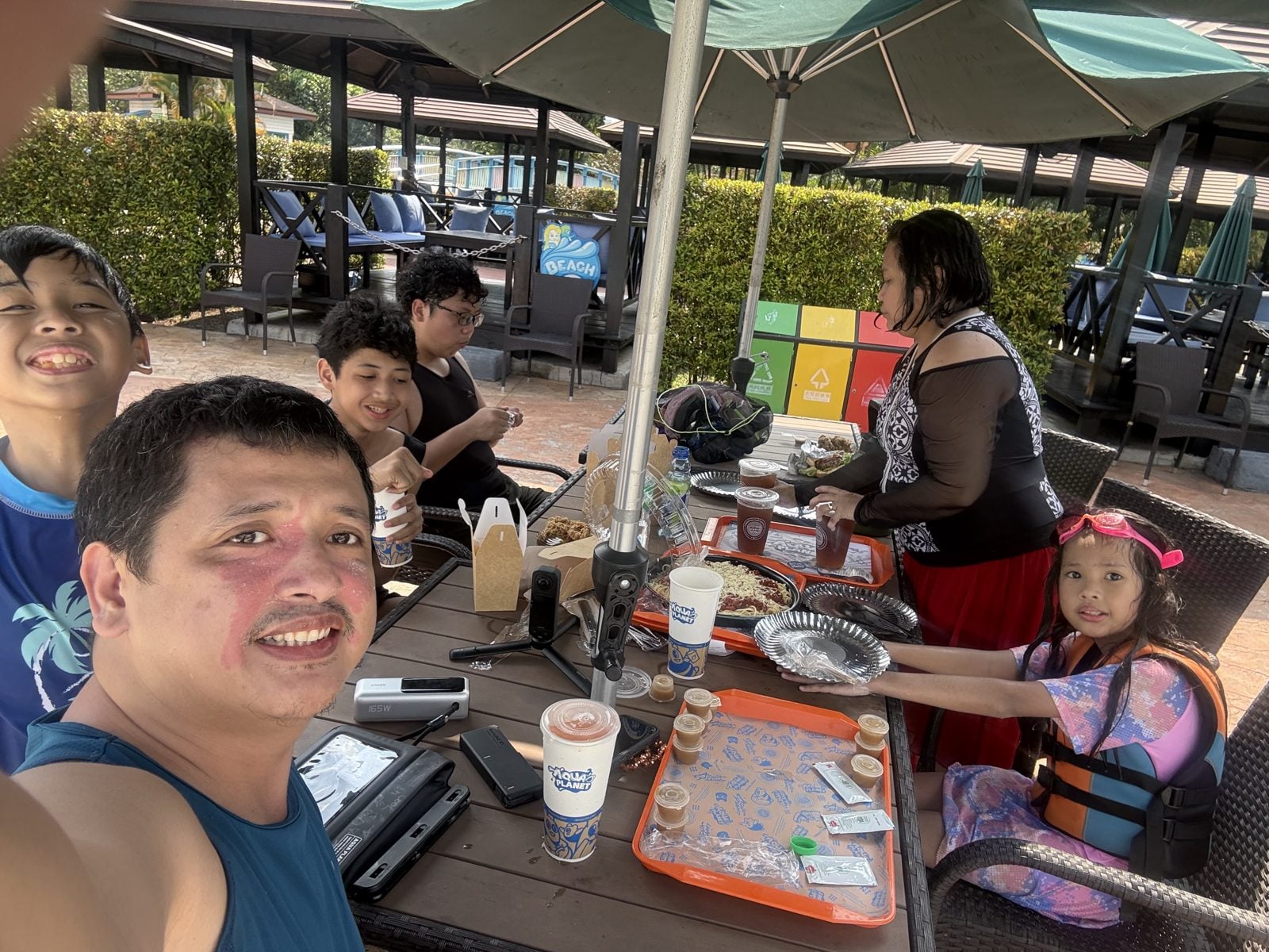 Family lunch selfie under the umbrellas at Aqua Planet