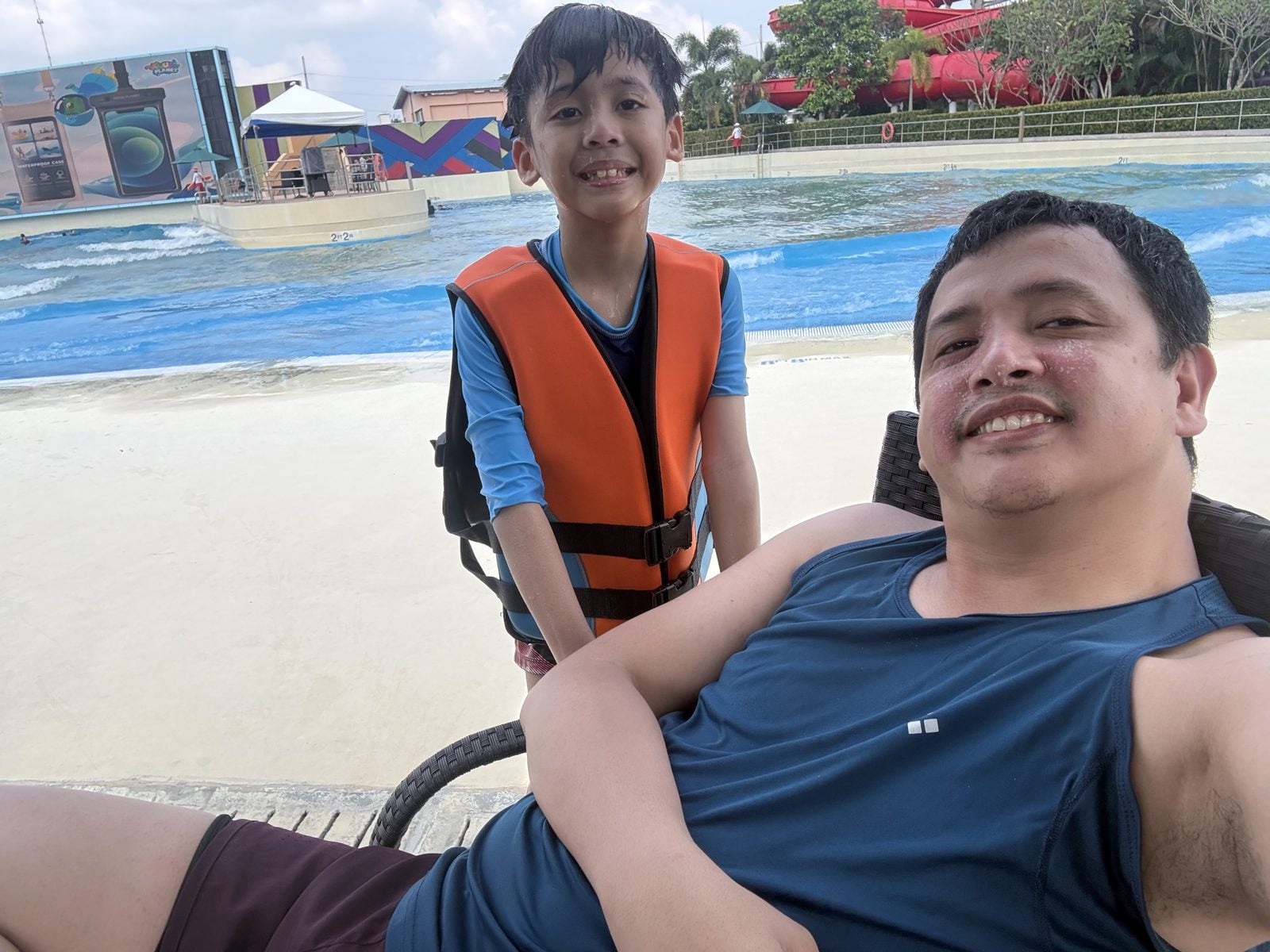 Dad and son in a life vest at the Aqua Planet wave pool