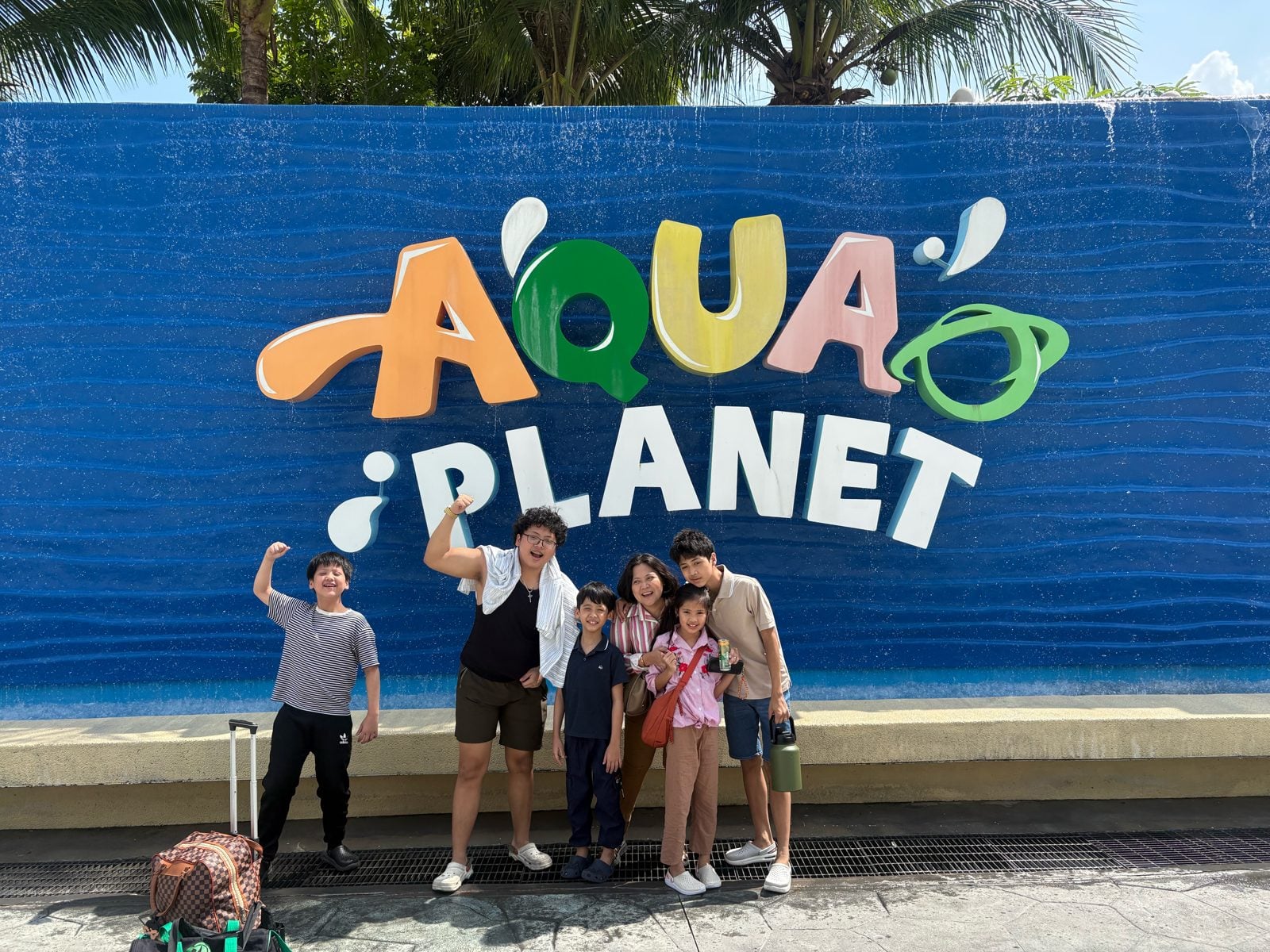 Family photo at the Aqua Planet sign