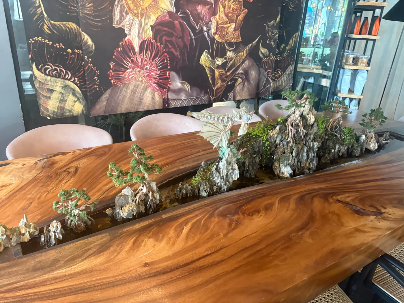 Long wooden table with a bonsai garden down the middle at Brew and Barrel New Manila