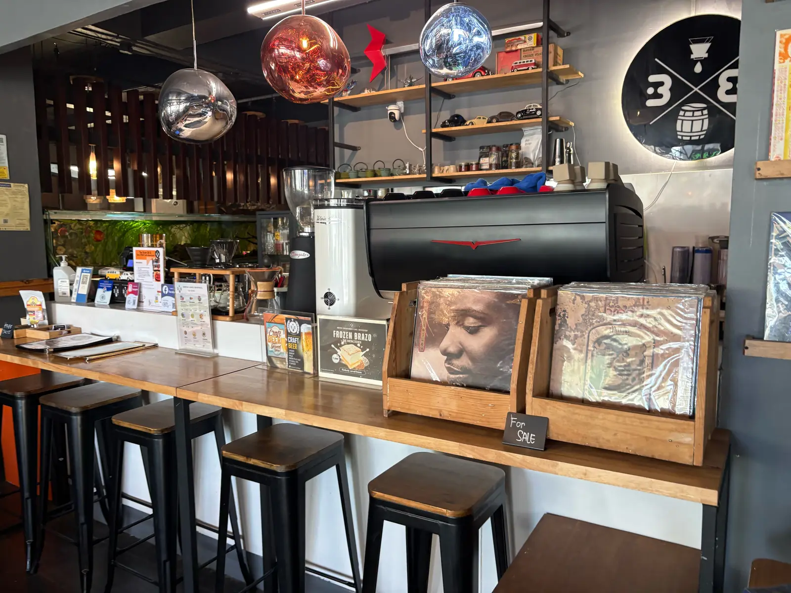 Coffee bar at Brew and Barrel New Manila, with espresso machine and vinyl records