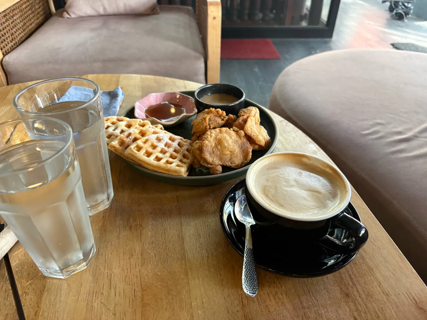 Chicken and waffles with syrup, gravy and a cup of coffee at Brew and Barrel New Manila