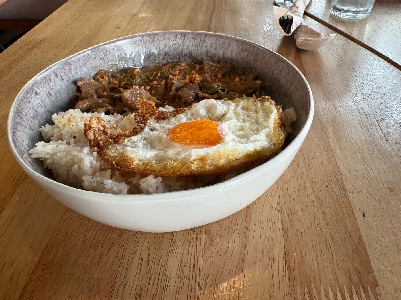 Garlic pepper beef with rice and a fried egg at Brew and Barrel New Manila