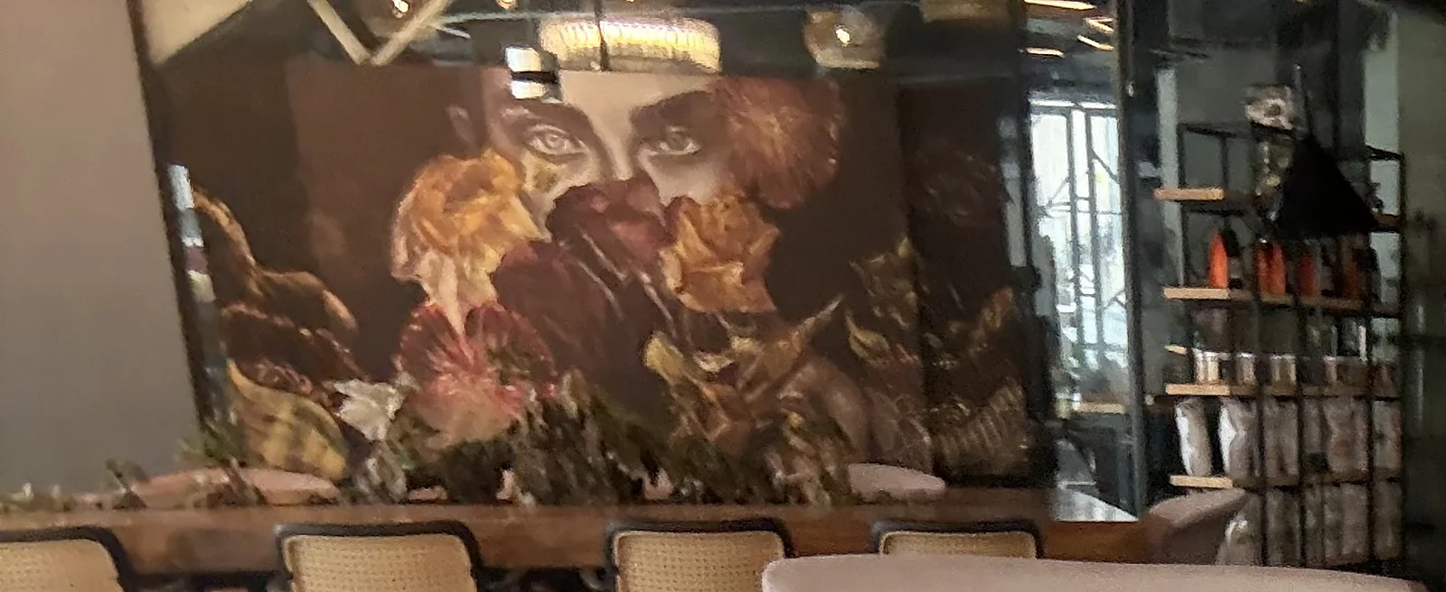 Inside Brew and Barrel New Manila: floral mural over the long wooden table