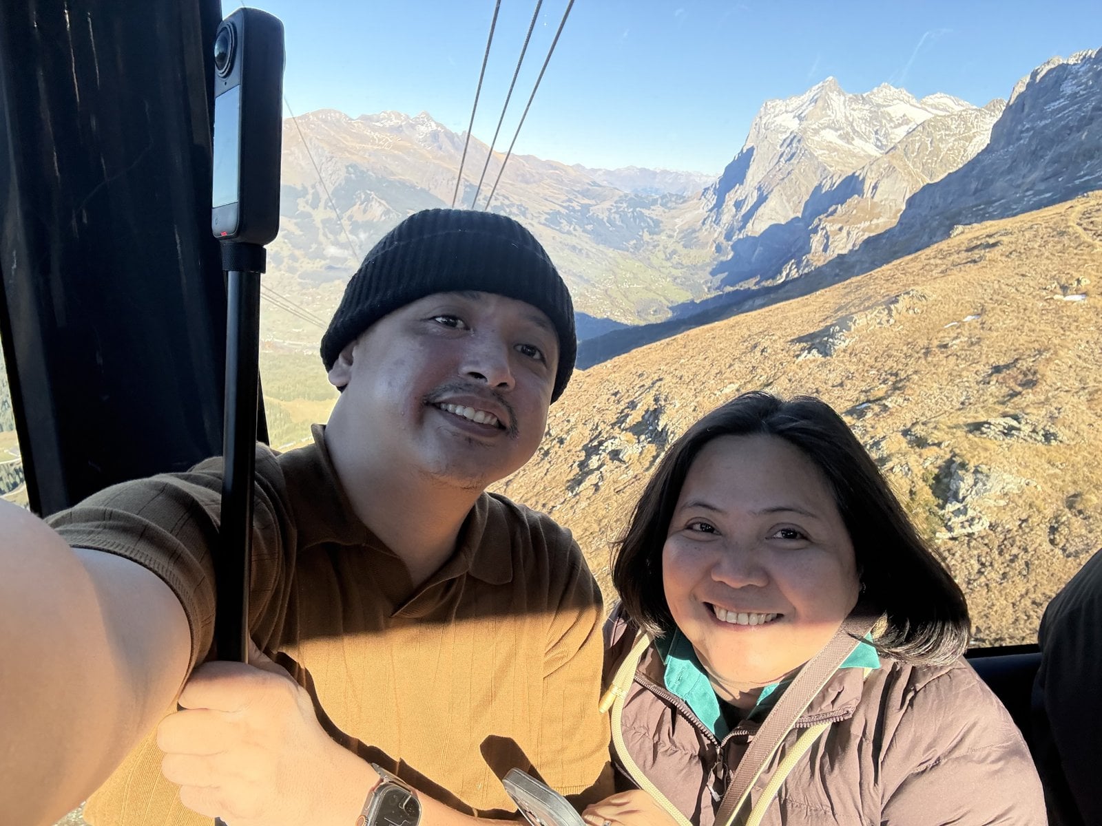 Paolo and Dimple in the Eiger Express gondola with the Wetterhorn behind them