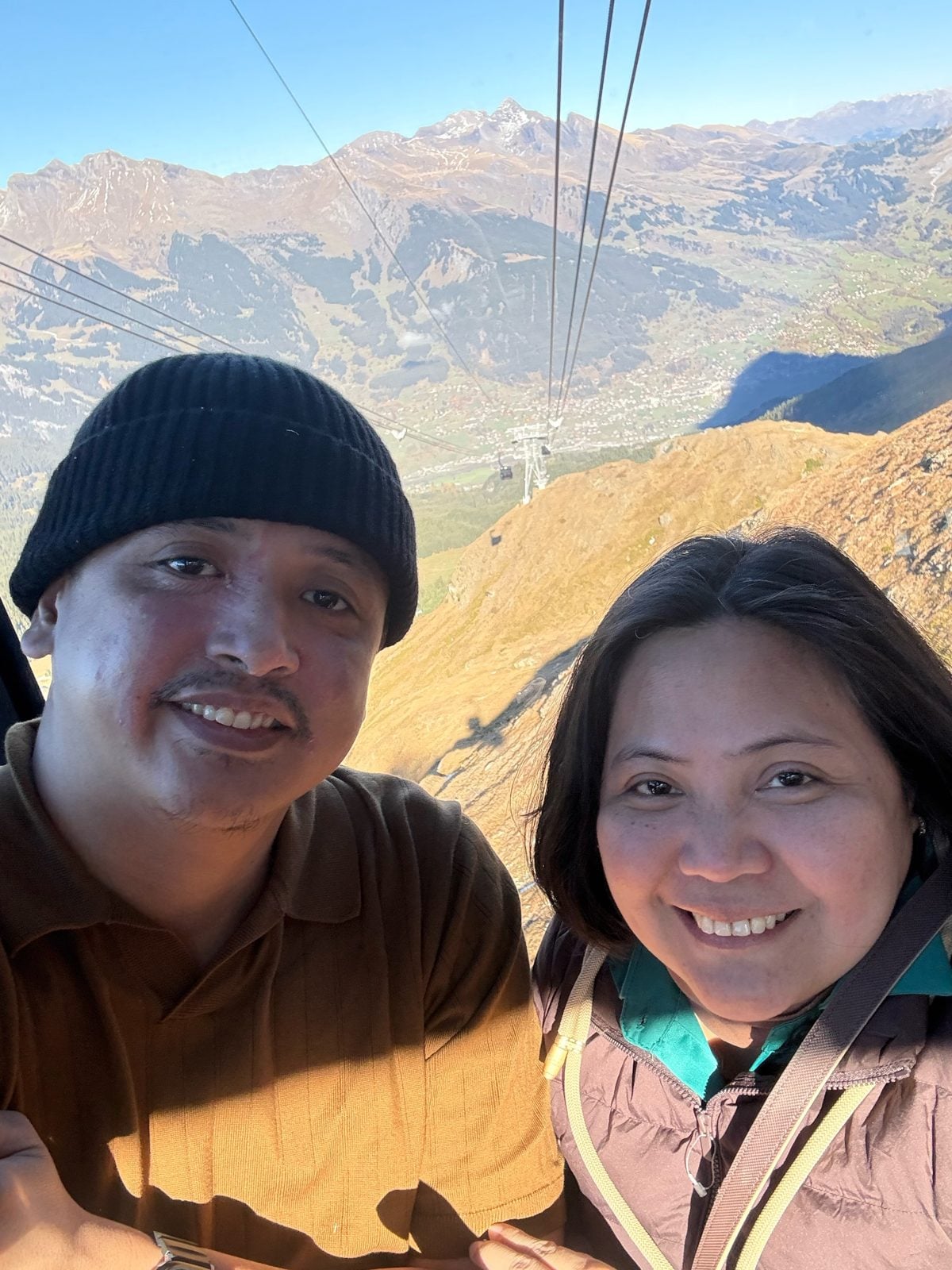 Paolo and Dimple smiling in the Eiger Express gondola on the way down to Grindelwald