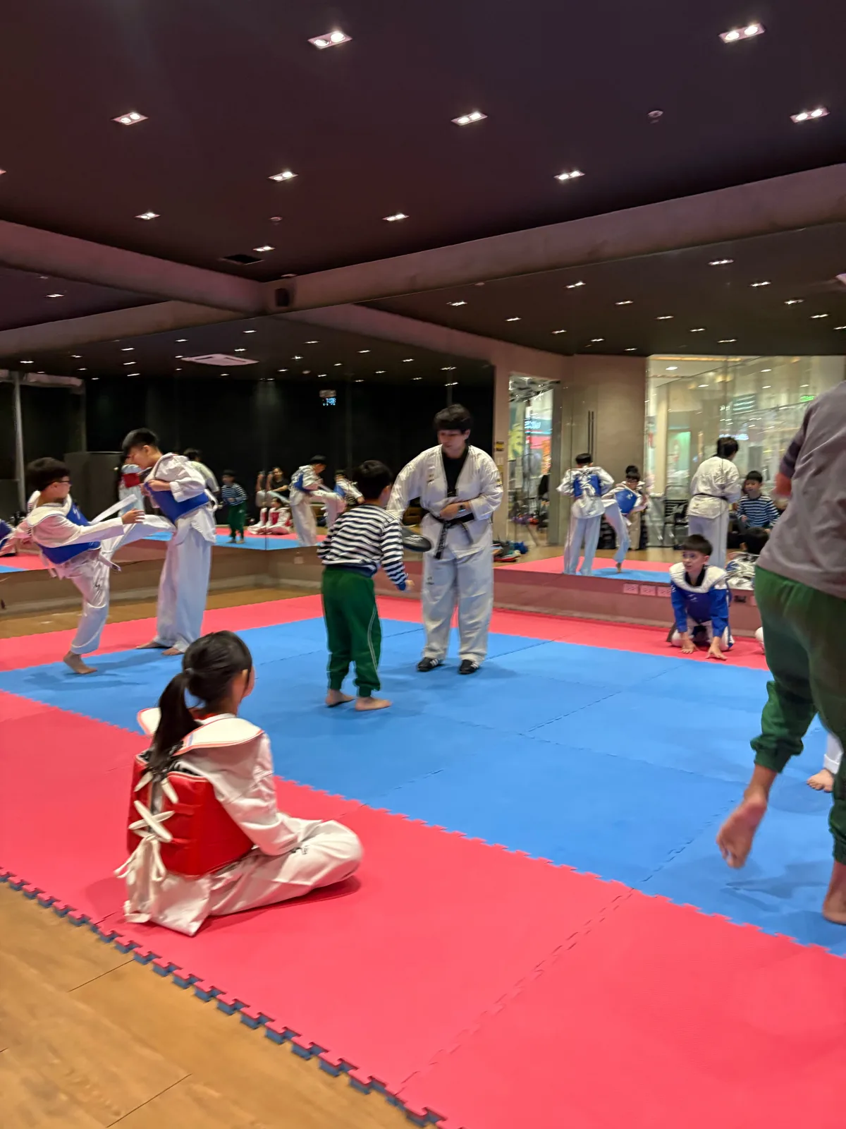 Sky watching the coach during kicking drills at his first taekwondo class
