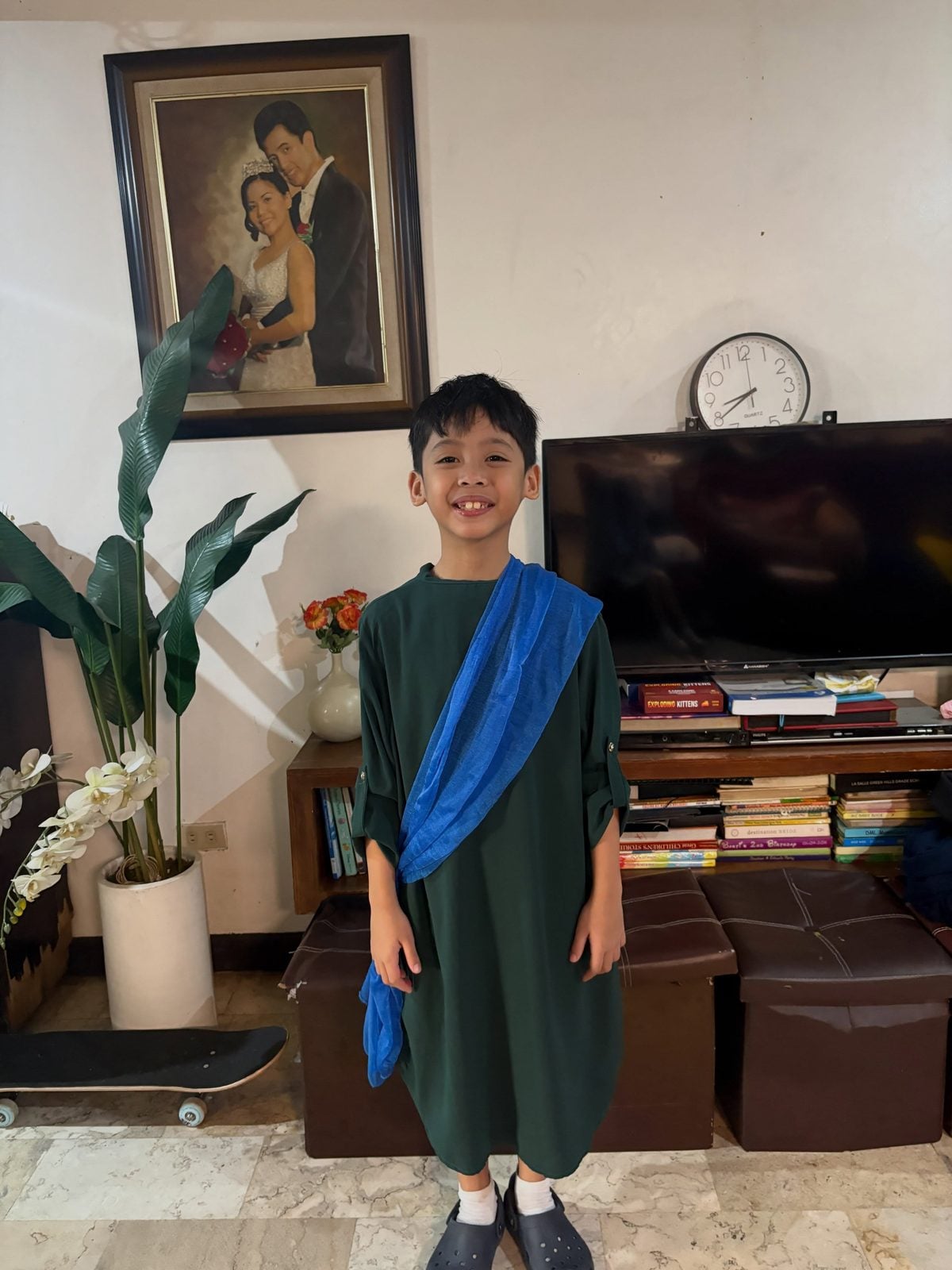 Sky dressed as Papa Joseph in a green robe with a blue sash