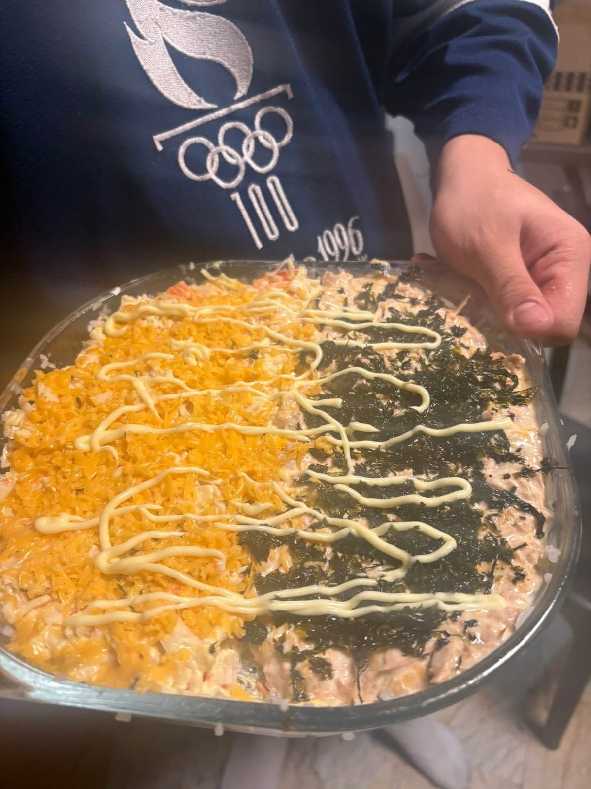 Close-up of a homemade sushi bake with cheese, nori and mayo