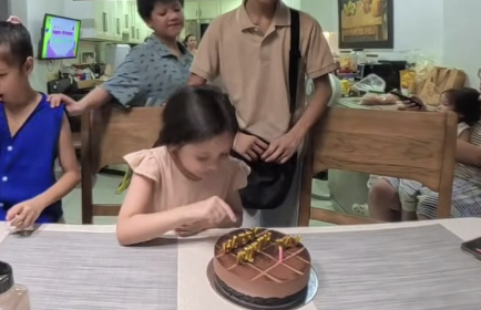 Lola blowing out the candle on her birthday cake