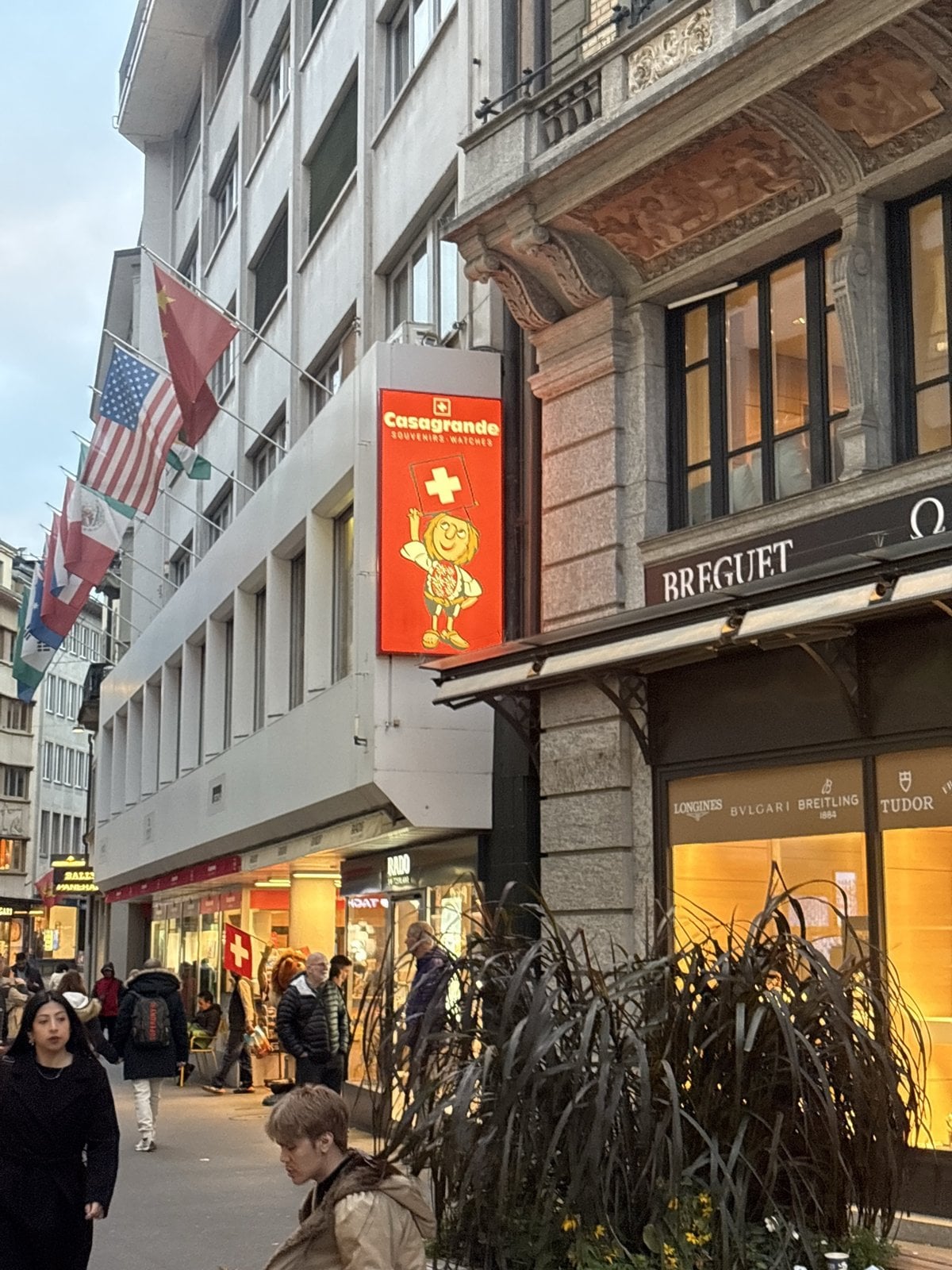 Lucerne shopping street with flags and watch shops near Schwanenplatz
