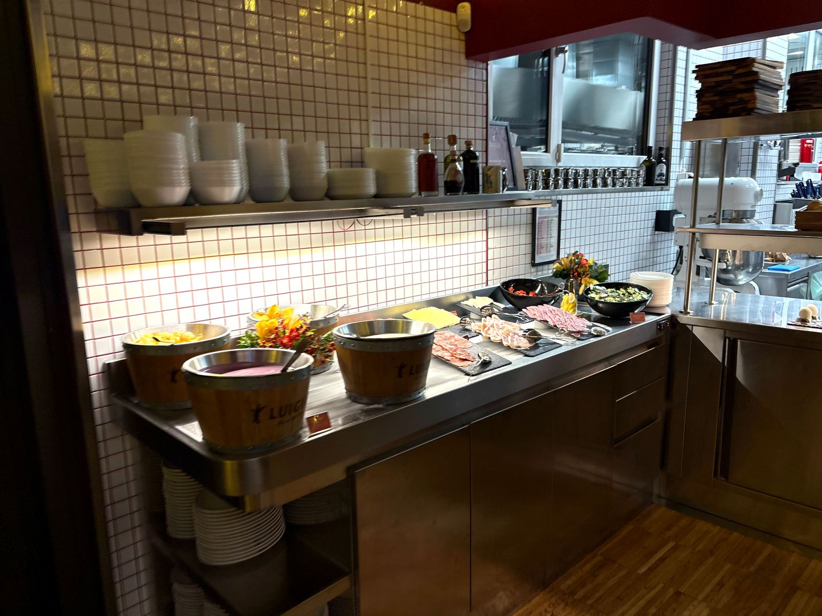 Cold cuts, cheese and yogurt buckets with the Luigia logo on the breakfast counter