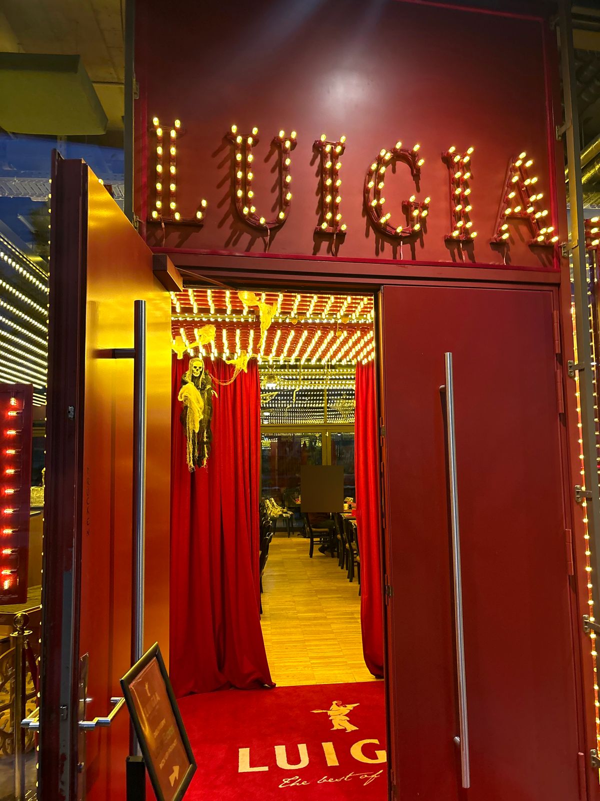 Luigia Opfikon entrance with red curtains and Halloween decorations
