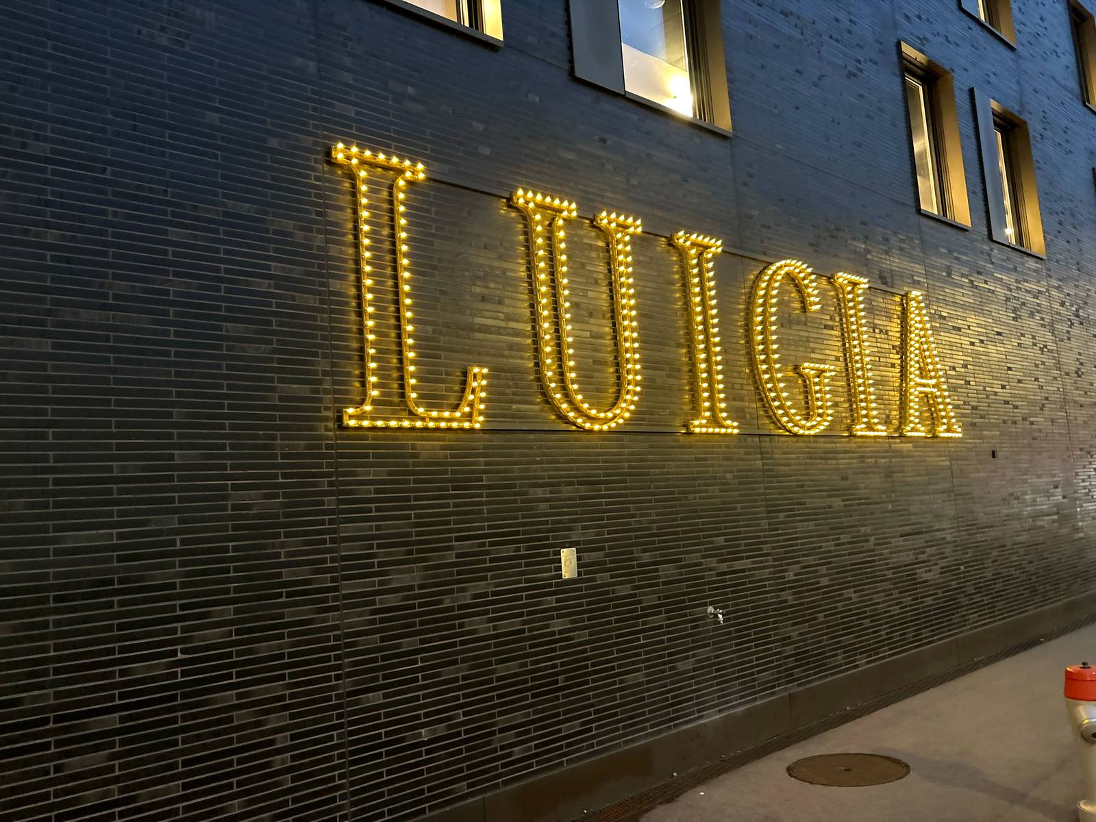 LUIGIA marquee-lit sign on the outside wall of the restaurant in Opfikon
