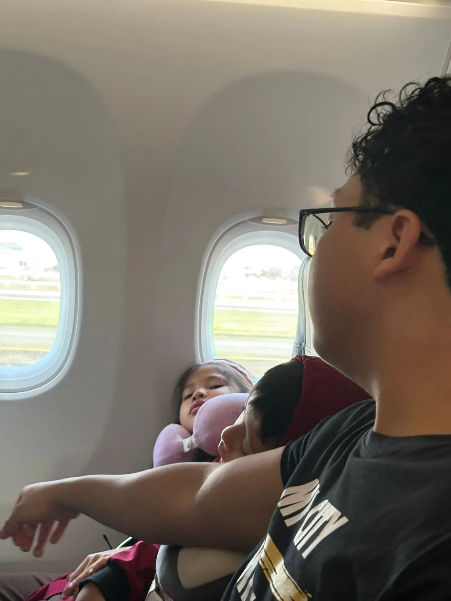 Boy looking out the plane window before take-off from NAIA Terminal 3