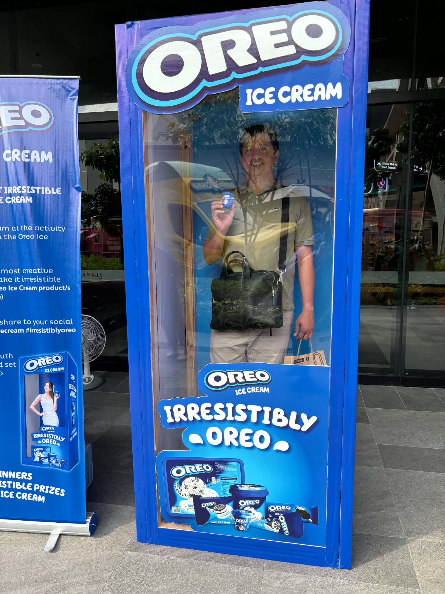 Posing with an Oreo ice cream cup inside the Oreo photo box
