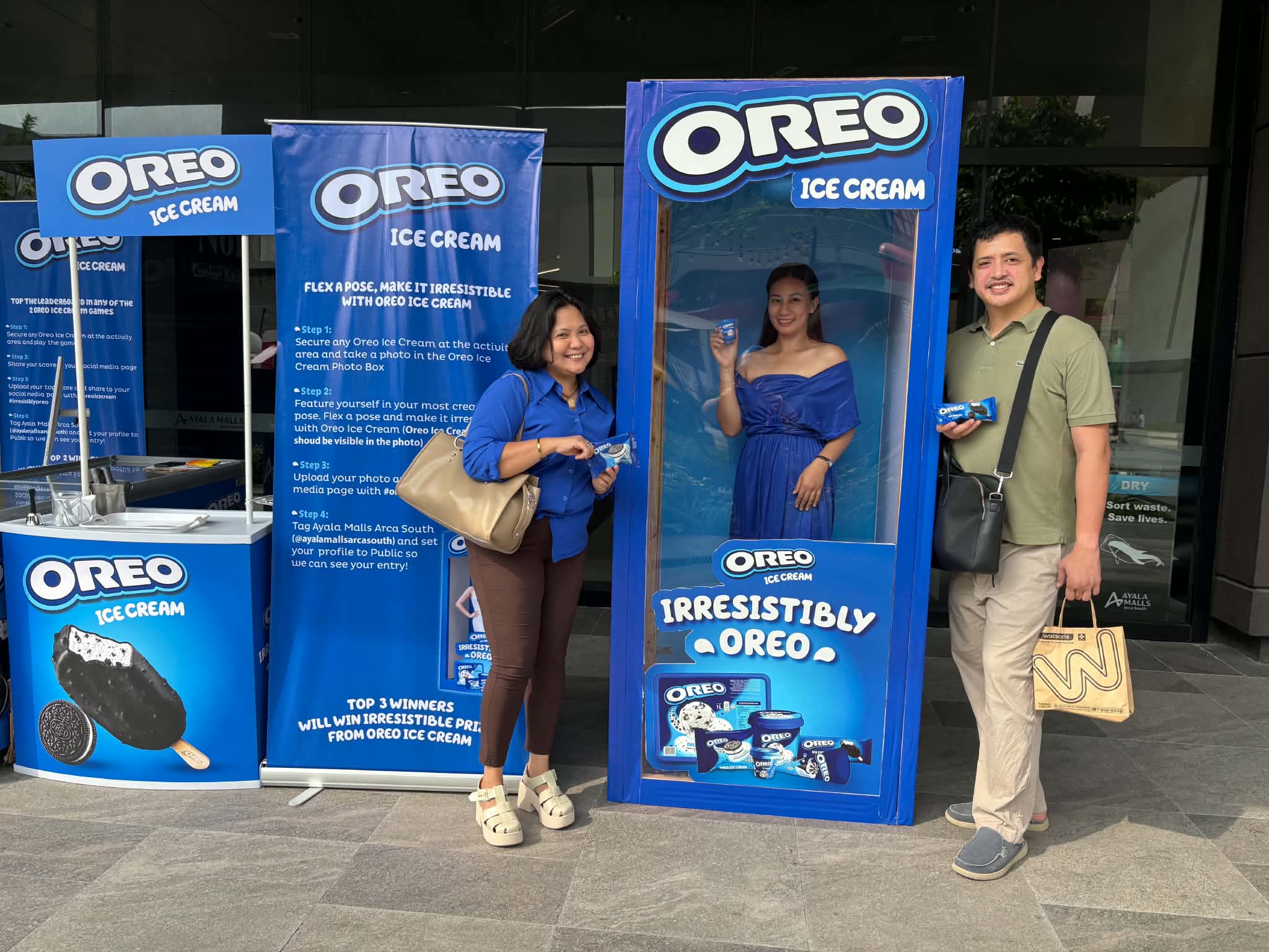 Family photo beside the Oreo Ice Cream photo box and game booth at Arca South