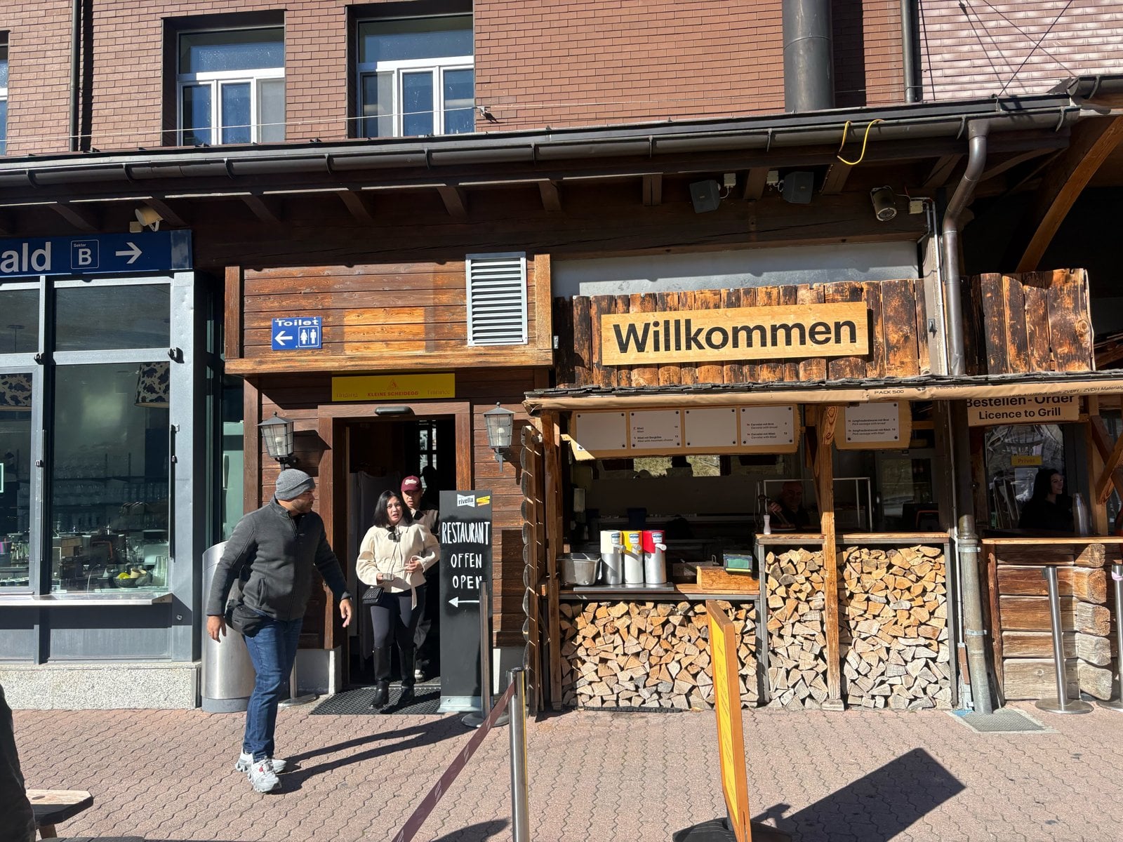 Entrance of the Kleine Scheidegg Mountain Restaurant with the Willkommen sign