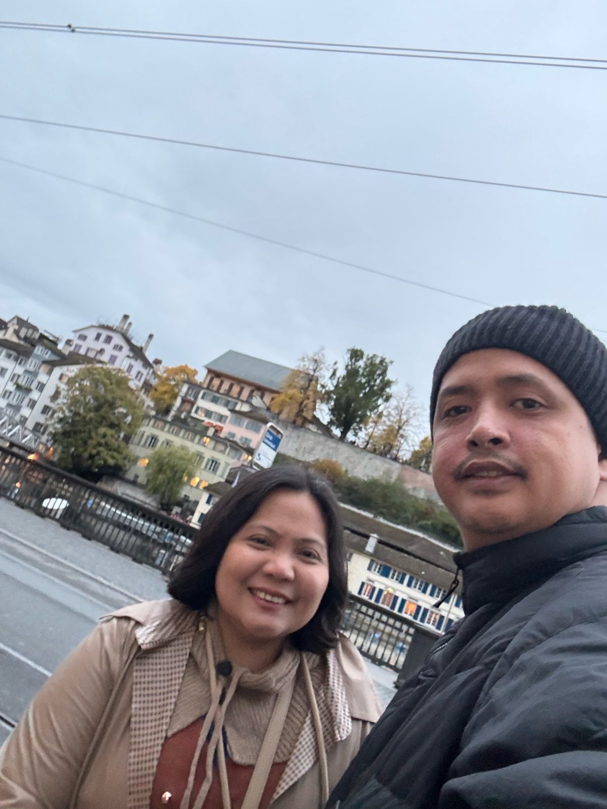 Lights coming on along the Limmat river in Zurich Old Town