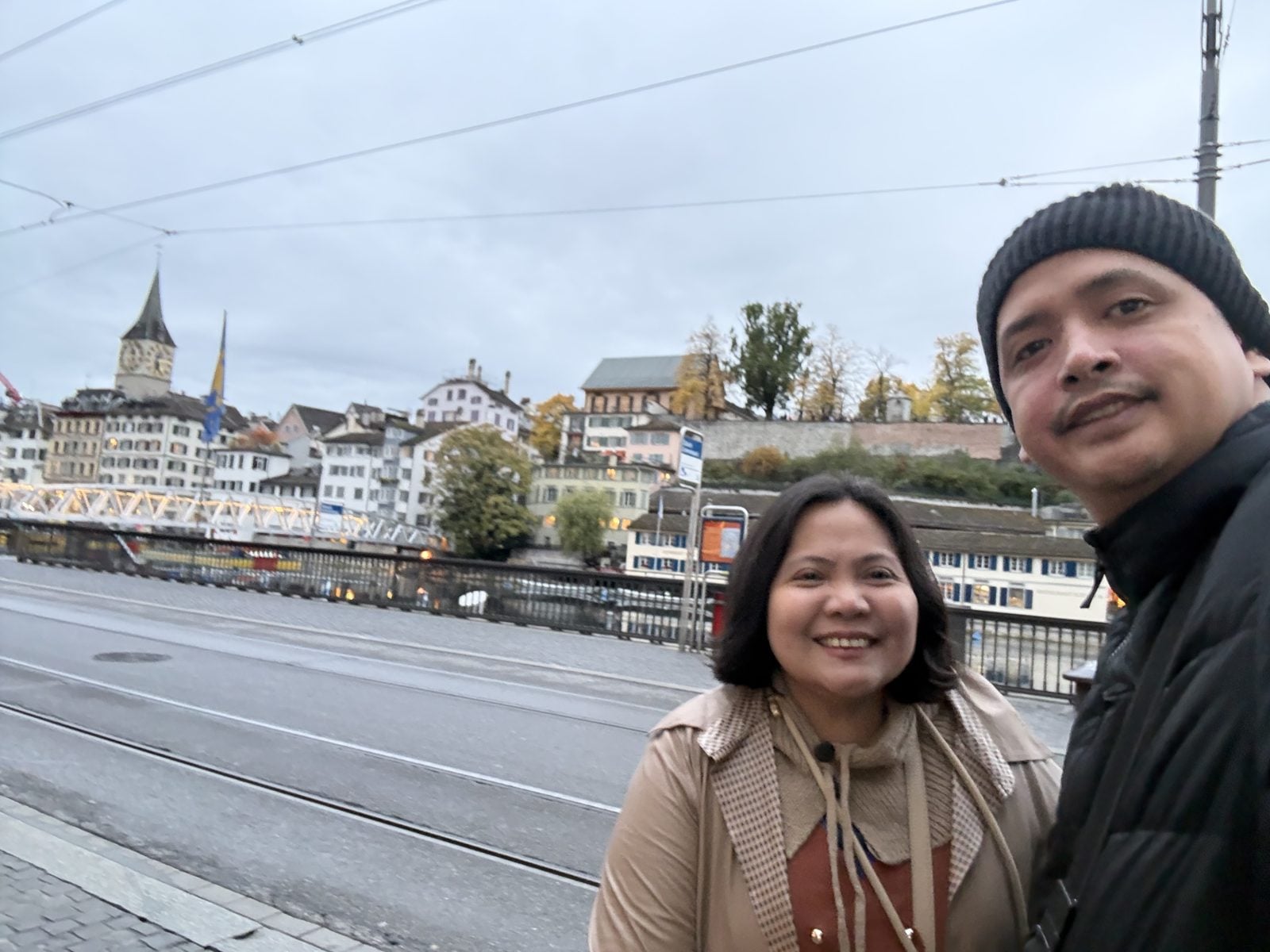 St. Peter's clock tower behind us by the Limmat river in Zurich at dusk