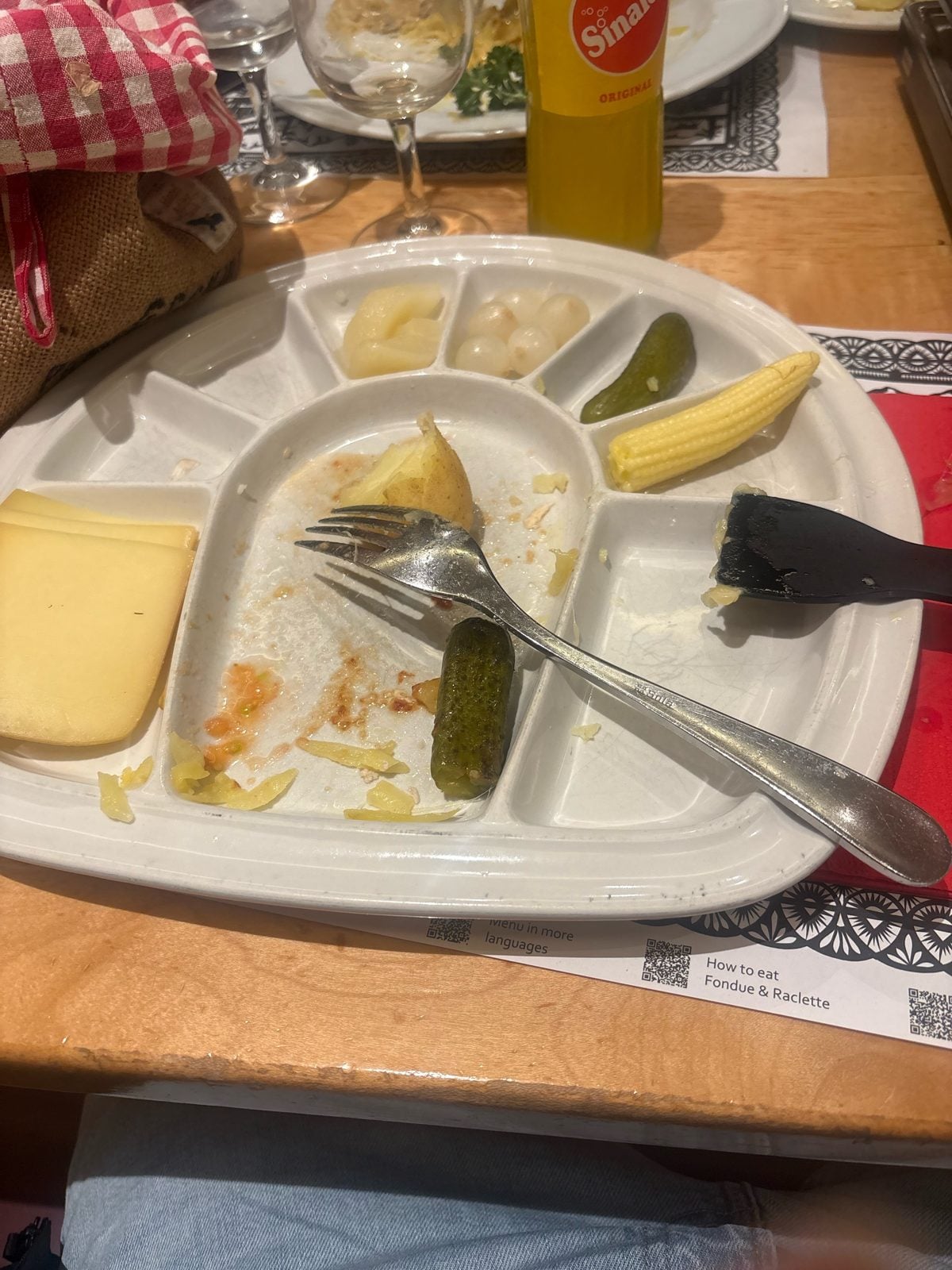 Swiss Chuchi chicken raclette with potatoes, pickles, pearl onions and baby corn