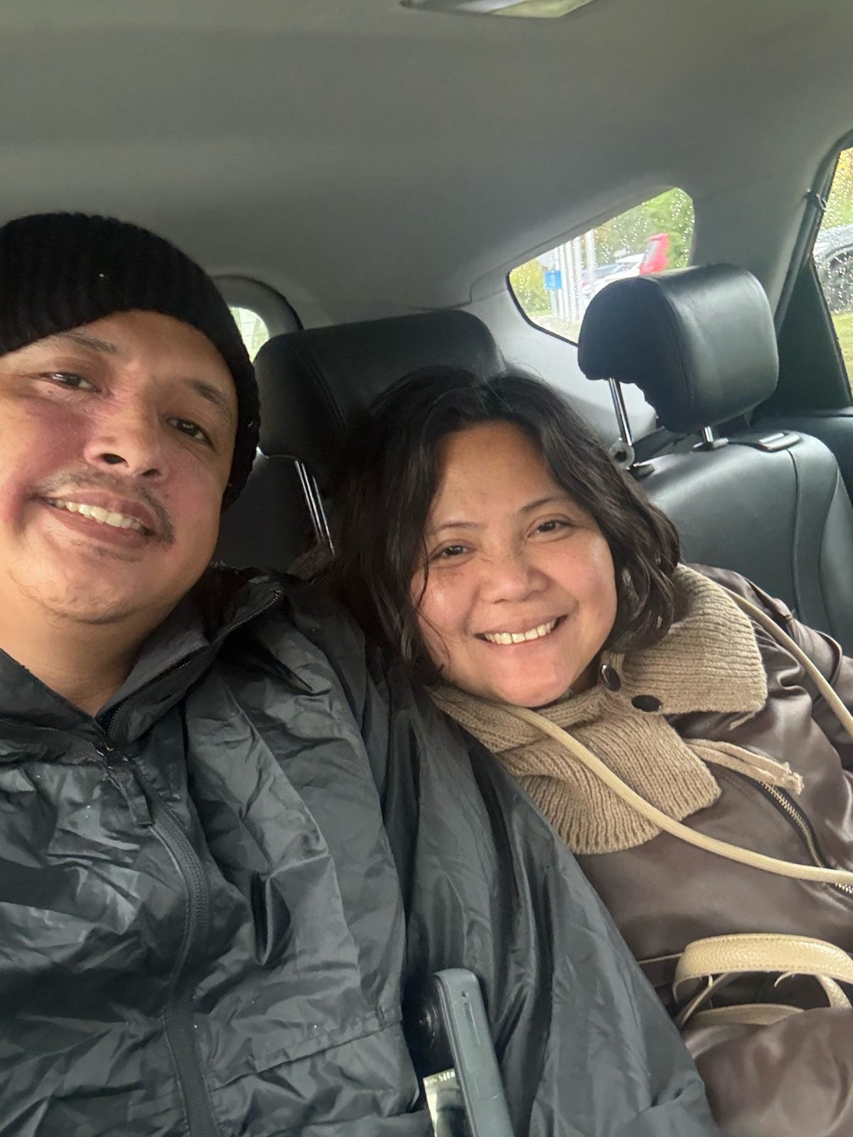 Paolo and Rosed in a car on a rainy Zurich day