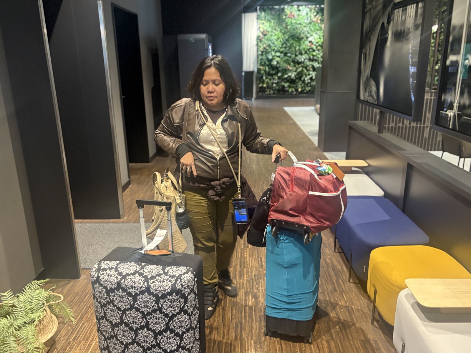 Dimple with our luggage at check-in in the Radisson Hotel & Suites Zurich lobby