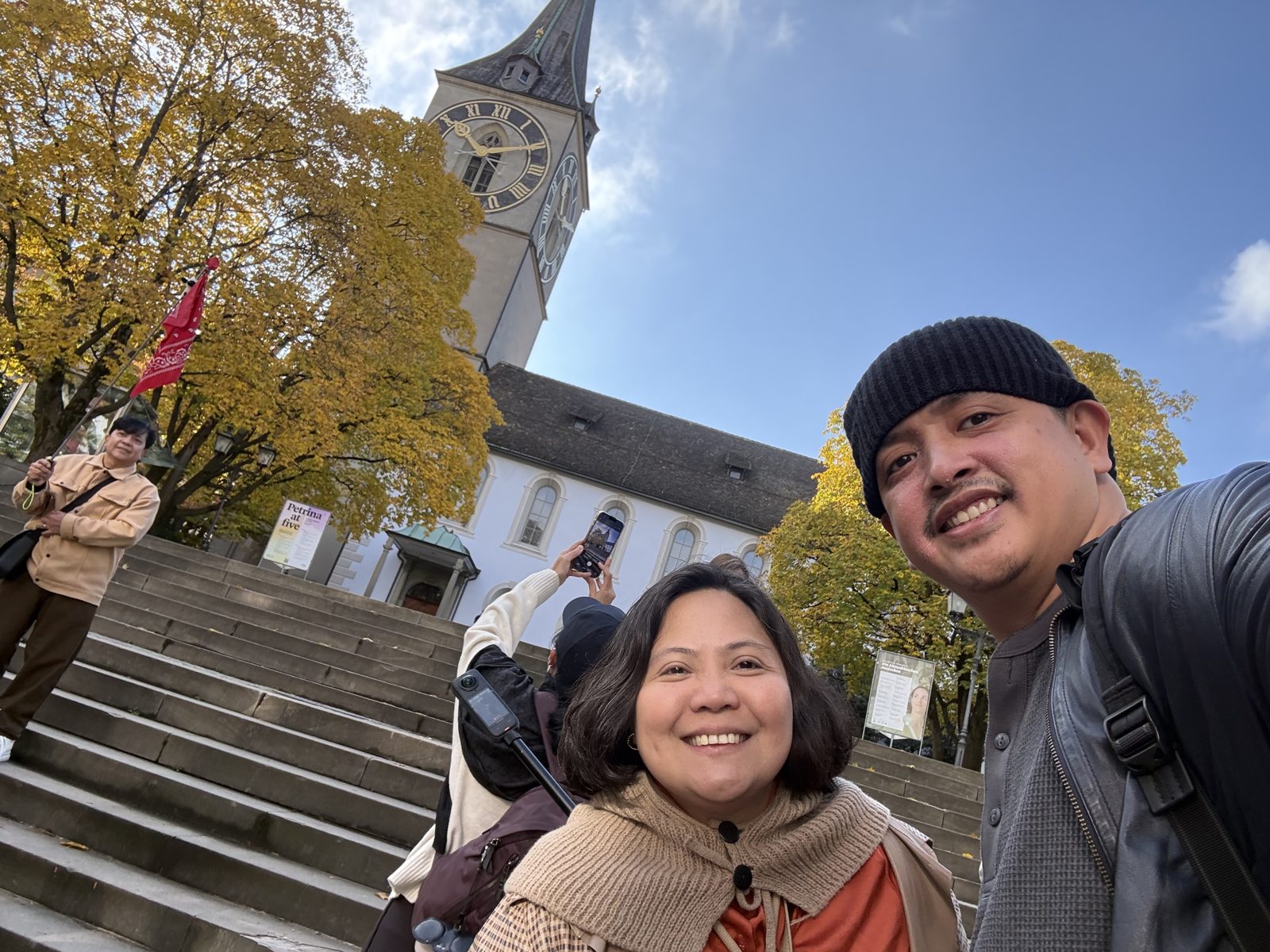 Dimple and Paolo on the steps below St. Peter's Church and its giant clock